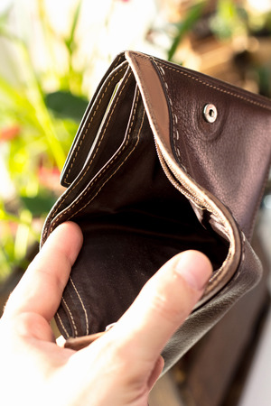Hand with empty wallet as banrupt concept.の写真素材