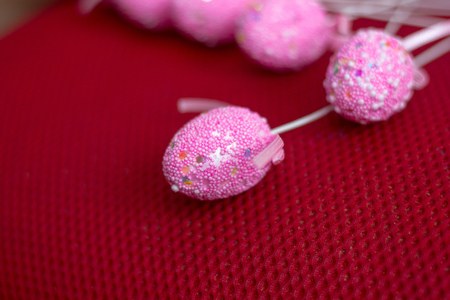 Easter eggs on a sticks over the red backgroundの写真素材