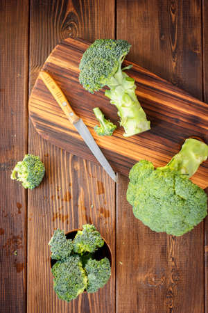 Fresh organic broccoli, cutted on kitchen boardの写真素材