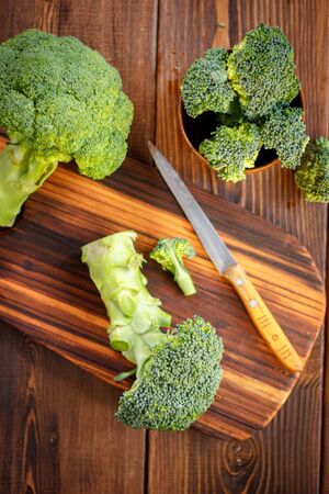 Fresh organic broccoli, cutted on kitchen boardの写真素材