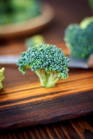 Fresh broccoli florets staying on the kitchen board like a treeの写真素材