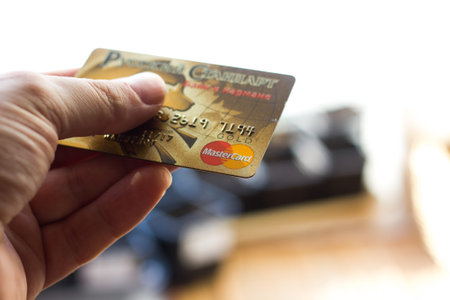 Ryazan, Russia - February 27, 2018: Customer hods Mastercard Gold ready to pay.