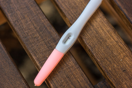 Negative pregnancy test over the brown wooden latticeの写真素材