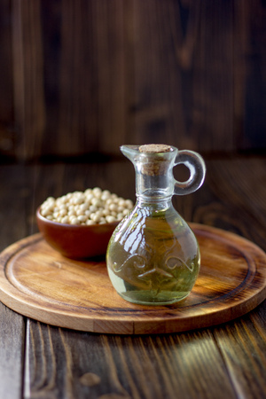 Natural soy bean oil with soybeans near itの写真素材