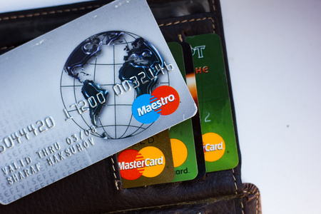 Ryazan, Russia - February 27, 2018: Credit card of Maestro brand over the leather wallet and number of cardsのeditorial素材