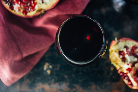 Fresh pomegranate juice in glass over black backgroundの写真素材
