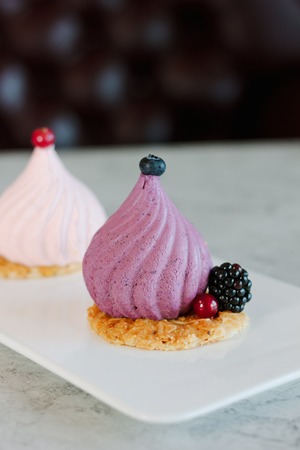 Purple souffle cake on white ceramic plate at restaurant.の写真素材