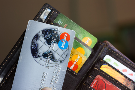 Ryazan, Russia - February 27, 2018: Credit card of Maestro brand over the leather wallet and number of cardsのeditorial素材