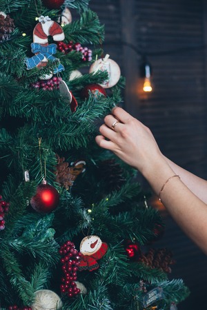 Beautiful girl arranges christmas tree - christmas and new year concept.の写真素材
