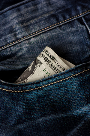 US dollar in a jeans pocket as a wealth conceptの写真素材