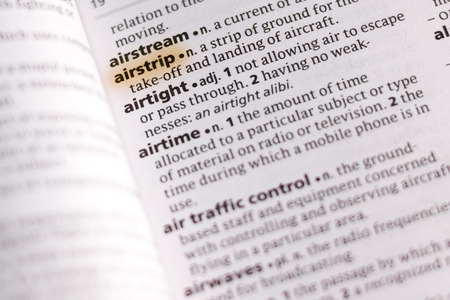 The word or phrase Airstrip in a dictionary highlighted with marker.の写真素材