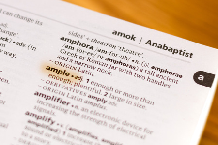 The word or phrase Ample in a dictionary highlighted with marker.の写真素材