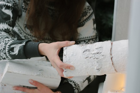 Loading firewood to a fireplace - christmas and new year concept.の写真素材