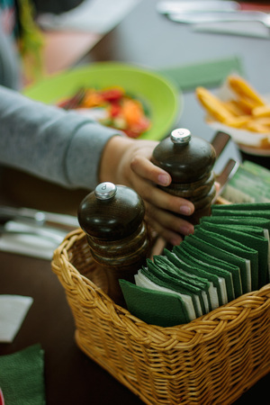 Kid hand and pepper grinder, great image for your needs.の写真素材