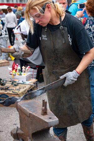 Ryazan, Russia - July 27, 2019: Woman blacksmith works with metal on the forge festivalのeditorial素材