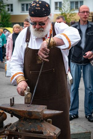 Ryazan, Russia - July 27, 2019: Blacksmith with hammer on street festival.のeditorial素材