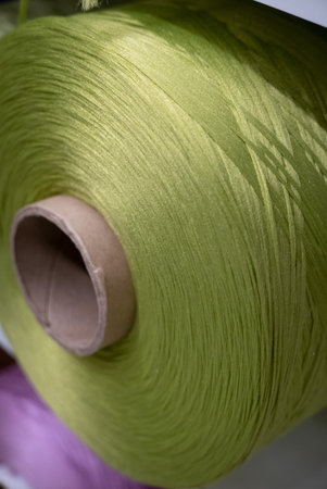 Green threaded cotton reel in a shop.