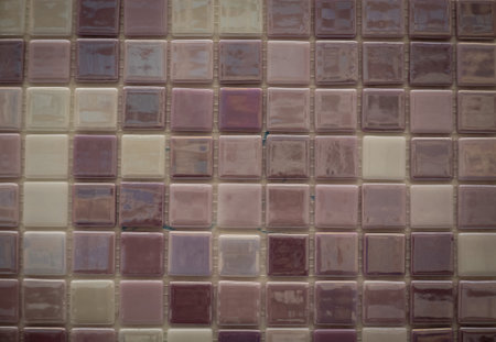 Purple ceramic mosaic on the wall as background.