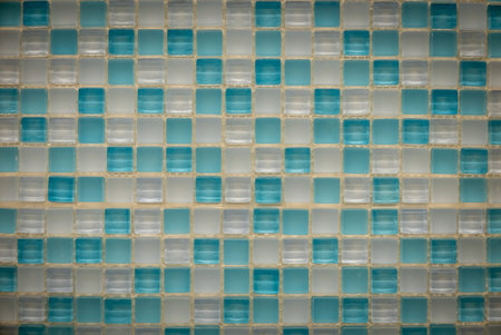 Light blue and white ceramic mosaic on the wall as background