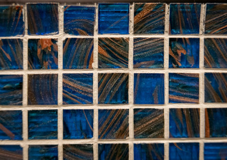 Blue ceramic mosaic on the wall as background.