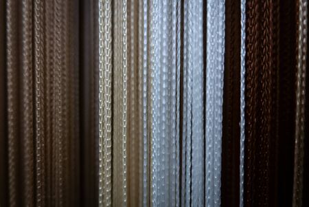 Textile strings and ropes hangs in a fabric shop. Abstract backgroundの写真素材