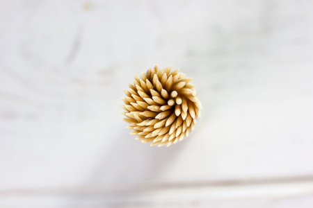 Bamboo toothstick in a case over the white table.