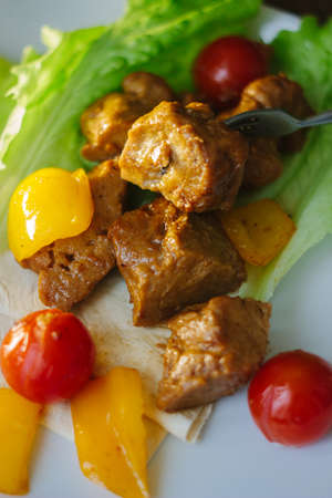 Seitan on white plate with the vegetablesの写真素材