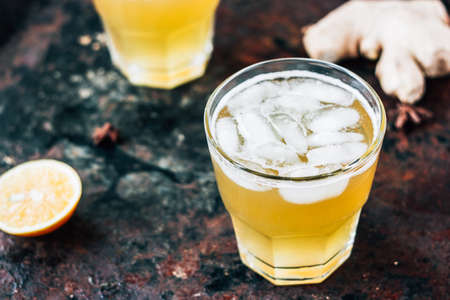 Ginger ale on black rustic surface with ice.の写真素材