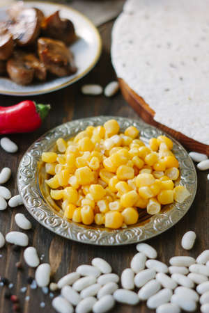 Organic corn on metal plateの写真素材