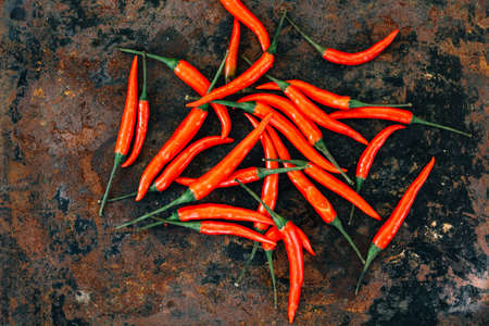 Red hot chili peppers over rustic surface - fresh and organic.の写真素材