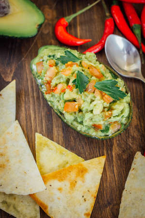 Avocado boat - guacamole dip in boat made from avocado skin.の写真素材