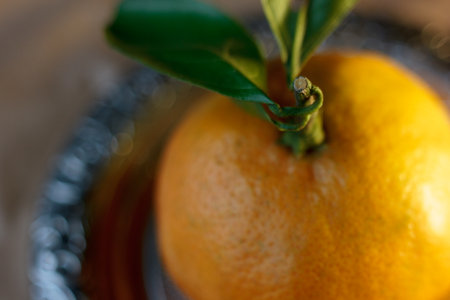 Mandarin orange known as mandarine on a metal plate over parchment paper.の写真素材
