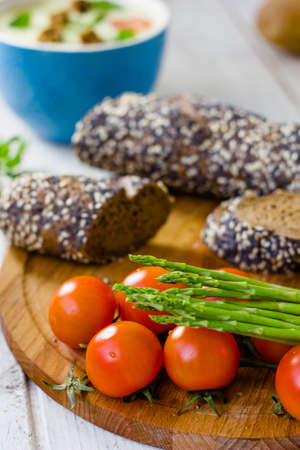 Fresh asparagus, bread and tomatoesの写真素材
