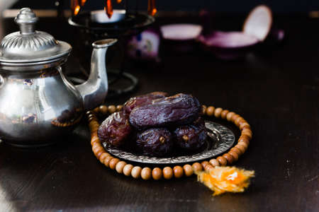 Date fruits on metal plate in ramadan month for iftar opening.の写真素材