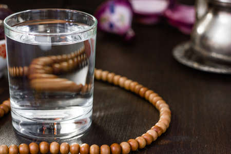 Glass of water for iftar opening on month ramadanの写真素材