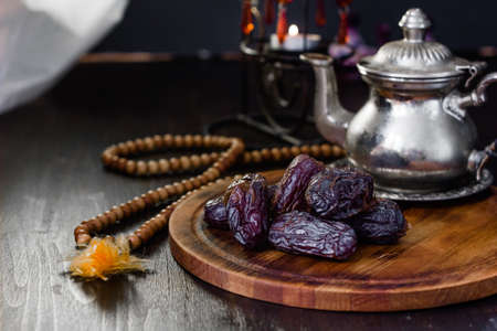 Dates for iftar on wooden board for ramadan month.の写真素材