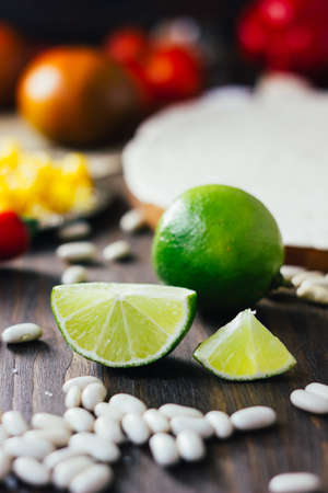 Pieces of green lime on wooden boardの写真素材