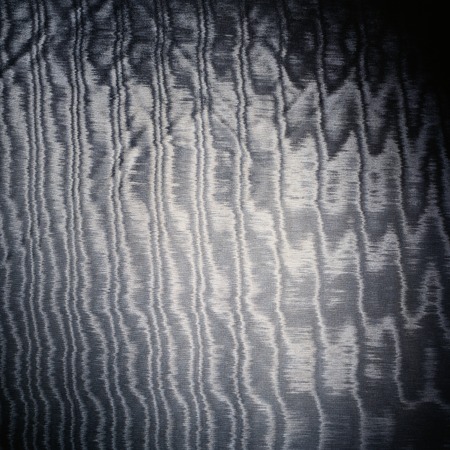 grey satin glossy cloth material texture with threads backgroundの写真素材