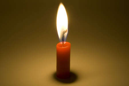the red candle is burning in the darkの写真素材