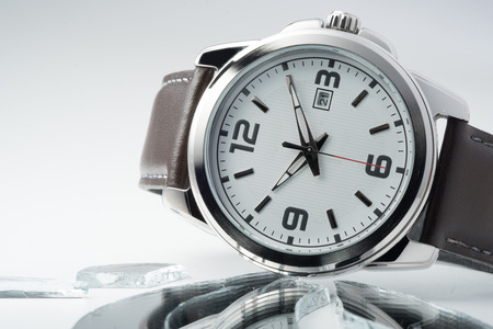 meteal luxury watch on white background and broken mirrorの写真素材
