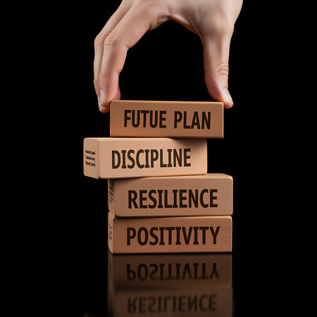 Conceptual image of human hand arranging wooden blocks with the words FUTURAL PLANNING, PLANNING, PLANNING on black backgroundの素材
