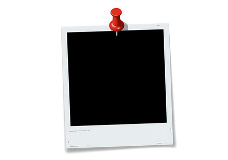 A blank instant photo frame is secured to a white surface by a vibrant red pushpin offering a clear and versatile space for inserting personal memories or professional messages The stark contrast of the black void within the photo frame against the crisp white border draws attention and emphasizes the importance of the image that will be added This image offers a clean modern aesthetic perfect for advertisements presentations or digital content creation The minimalist design and focus on simple elements allow the photo frame to easily integrate into various projectsの素材