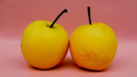 Top view of two pears with stem isolated on gray background. Fresh asian pears. Fresh pears ready to...