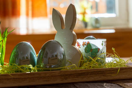 Easter decoration with egg and bunny on a tableの写真素材