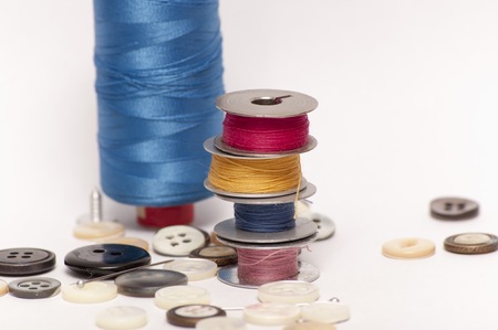 Buttons and cotton on a white tableの写真素材