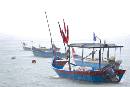 Fishing Boats in Tropical Rainstormの写真素材