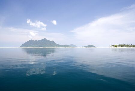 Image of remote Malaysian tropical islands with deep blue skies, crystal clear waters and coconut trees.の写真素材