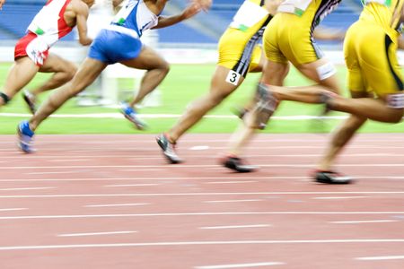 Image of 100 meters athletes in action with intentional blurring.の写真素材