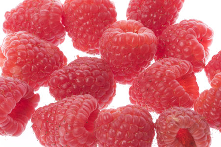 Isolated macro image of raspberries.