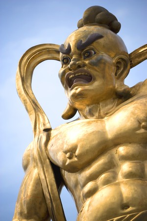 A giant statue of a guardian guarding the entrance to a Chinese temple in Malaysia.の写真素材